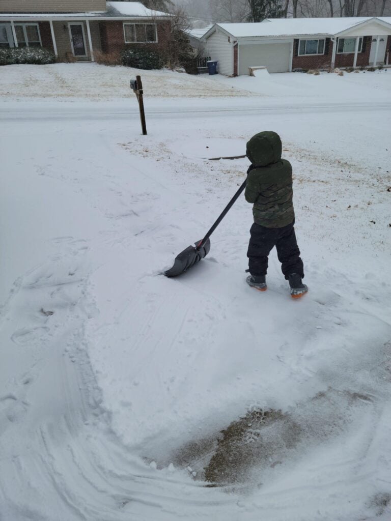 Our son shoveling driveways to make money