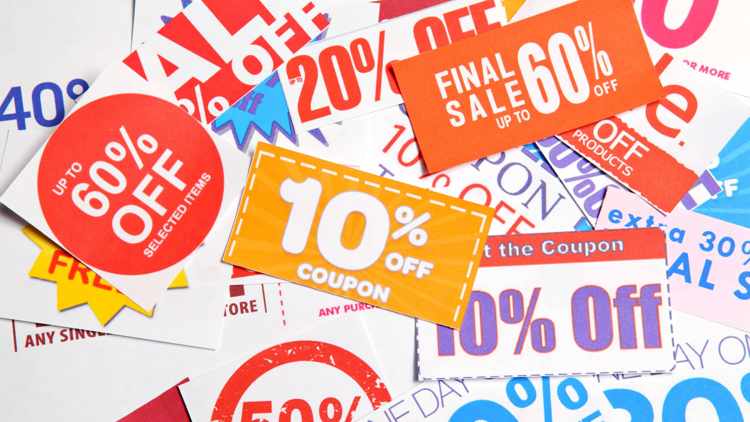 A collection of various discount and sale signs, including percentages like 60% off and 10% off, displayed on colorful, overlapping paper tags.