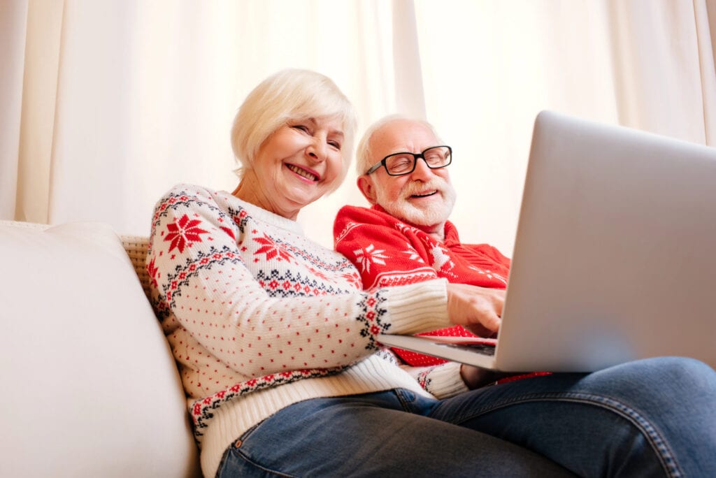 Senior couple using laptop. 