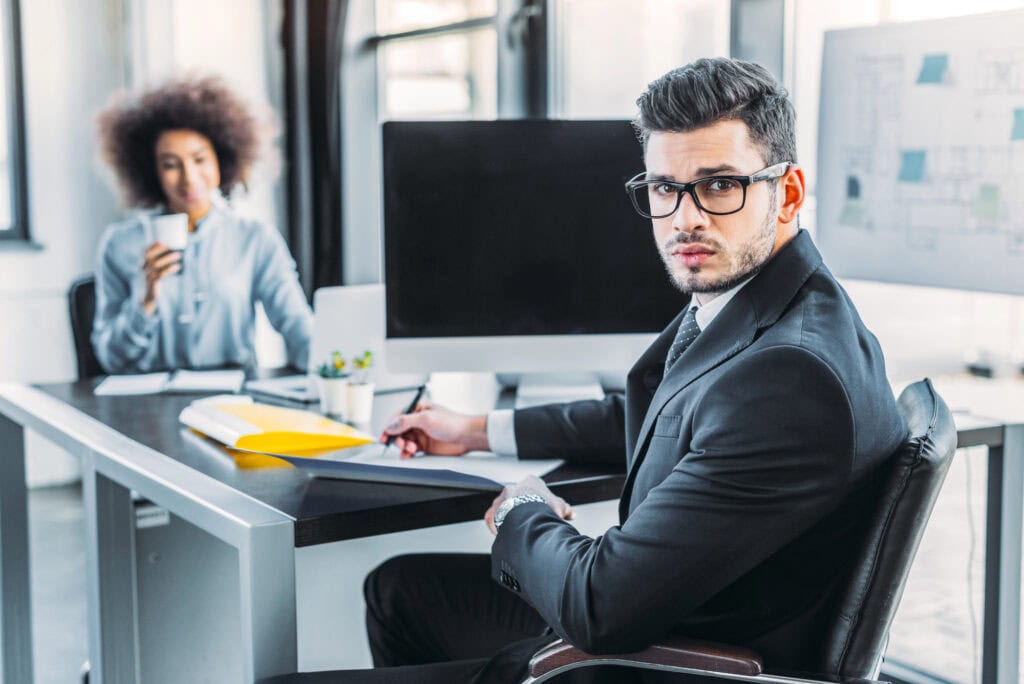 Businessman looking at camera in office