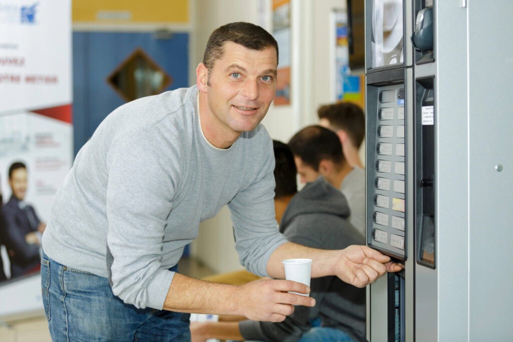 Man using coffee vending machine