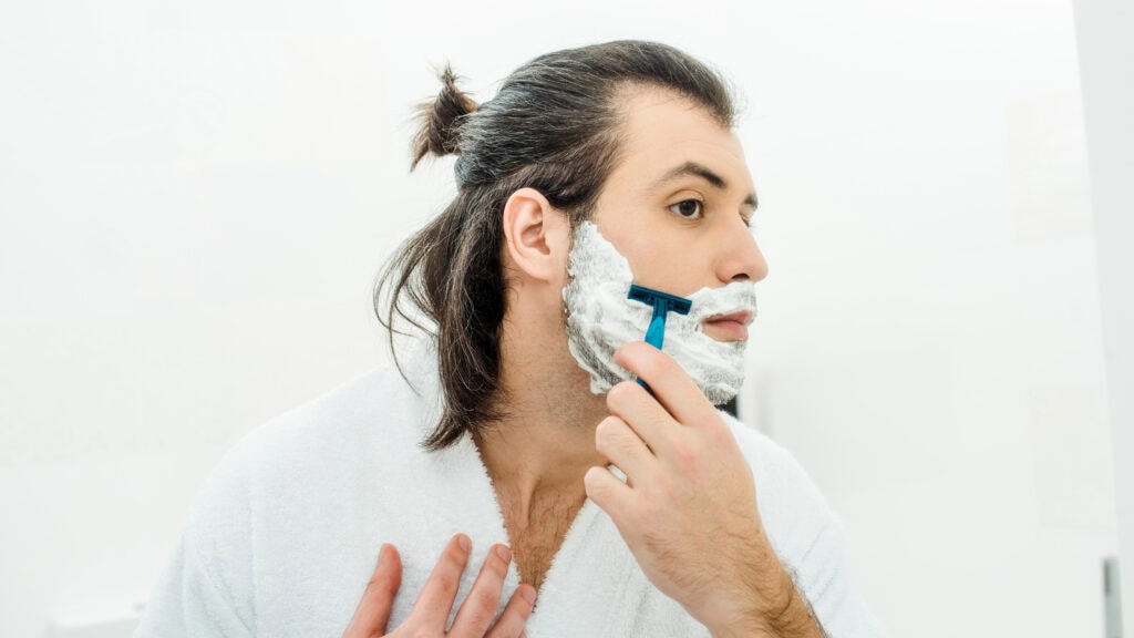 Man Shaving his beard