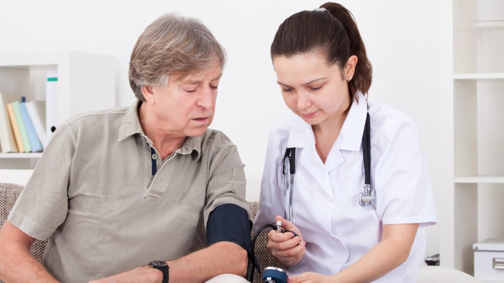 Doctor Measuring Blood Pressure Of Patient