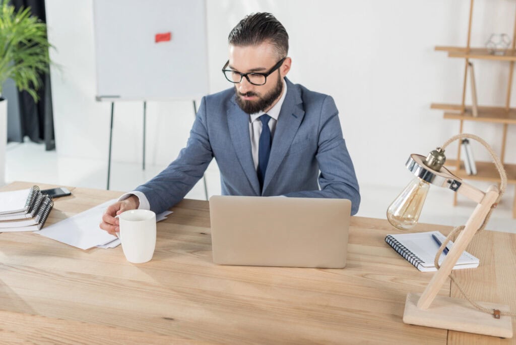 Businessman with coffee cup at workplace