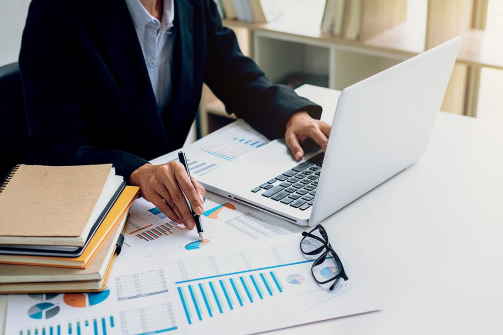 Business working at office with laptop, smartphone and documents