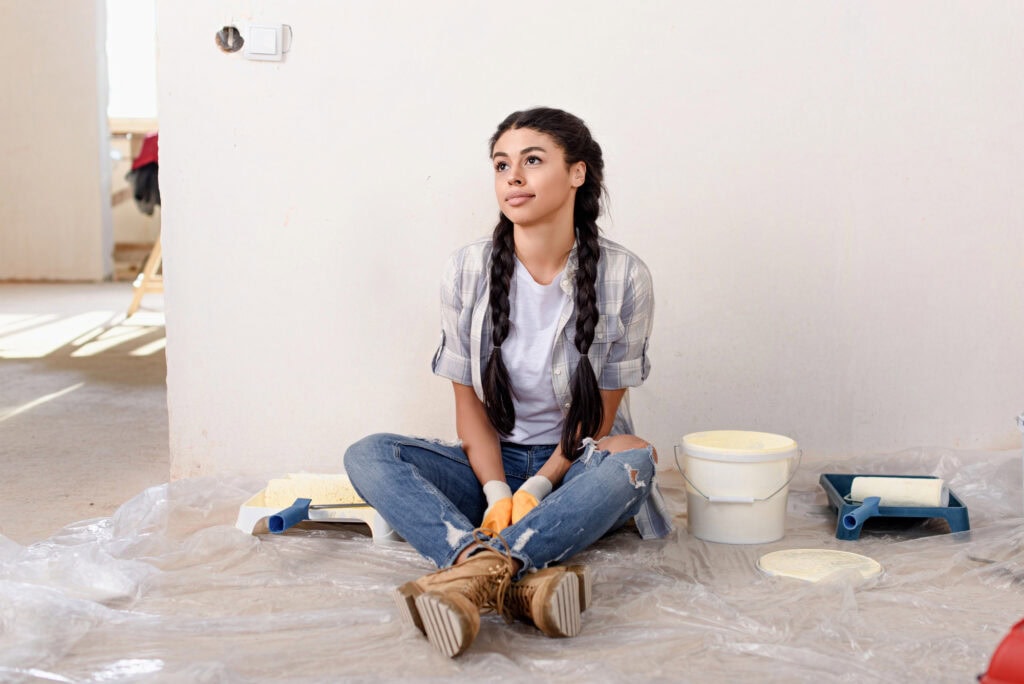 Thoughtful young woman looking away during renovation of new home
