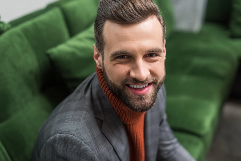 Portrait of smiling man in formal wear looking at camera