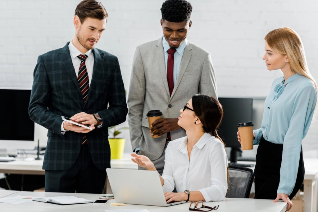 Multiethnic business colleagues in formal wear at workplace in office