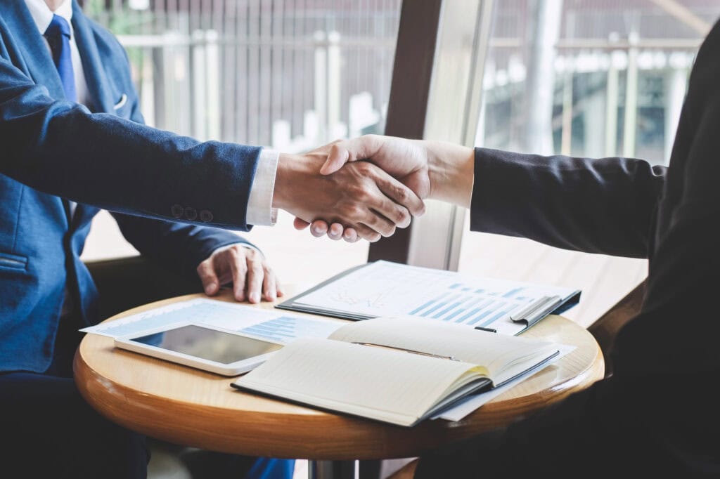 Finishing up a meeting, handshake of two happy business people
