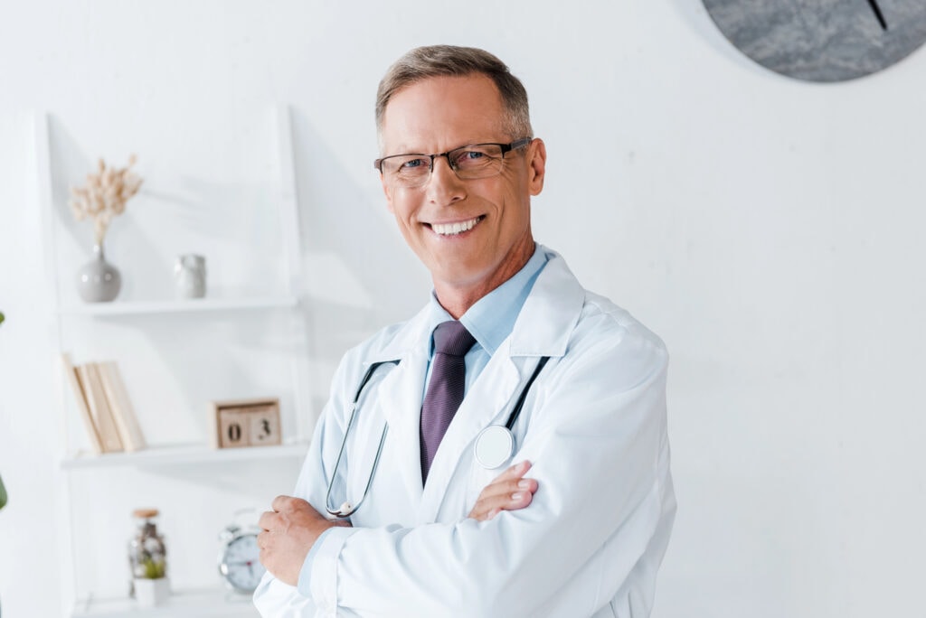 Doctor in white coat and glasses with crossed arms