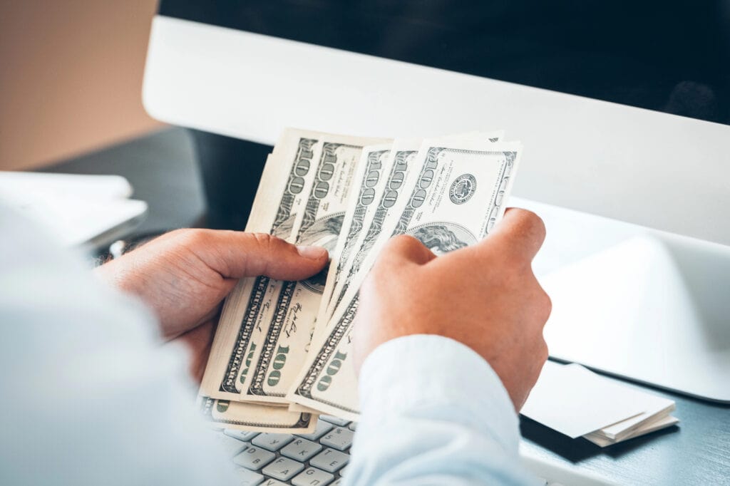 Caucasian hands counting dollar banknotes