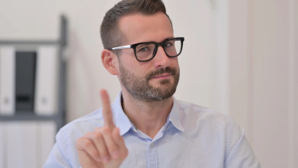 Portrait of Middle Aged Man showing No Sign by Finger