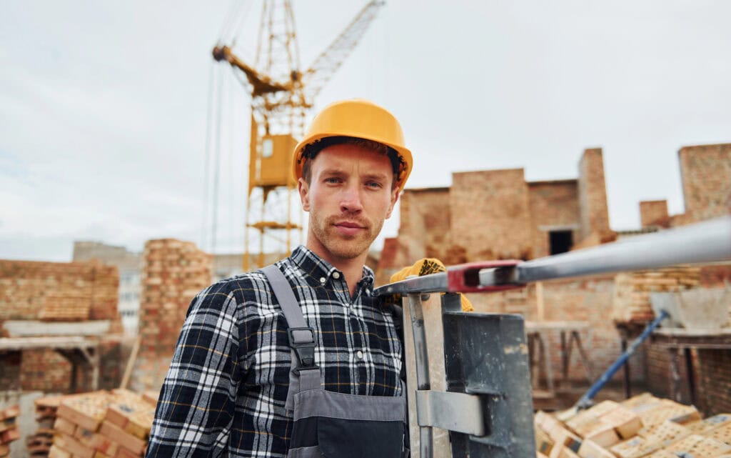 Construction worker in uniform and safety equipment have job on building