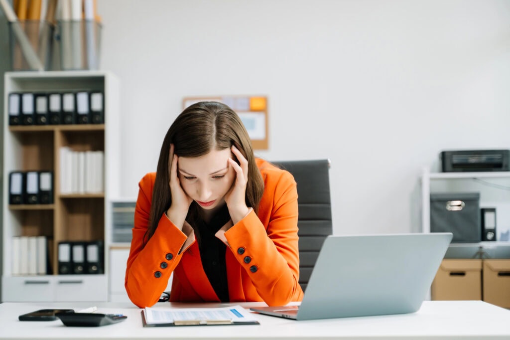 Overworked caucasian businesswoman suffering from migraine at office