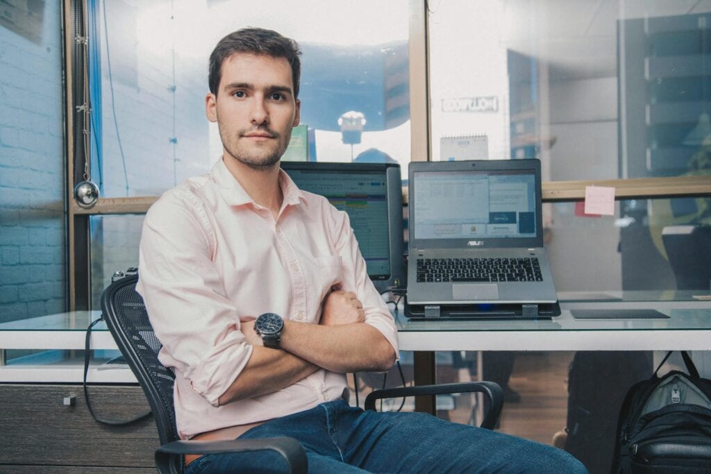 Serious man sitting with crossed arms