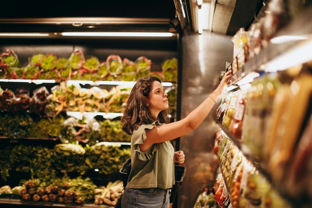 Woman Picking Out Items Off the Shelf At the Store