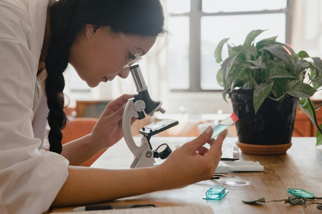 Side View of a Woman Using a Microscope