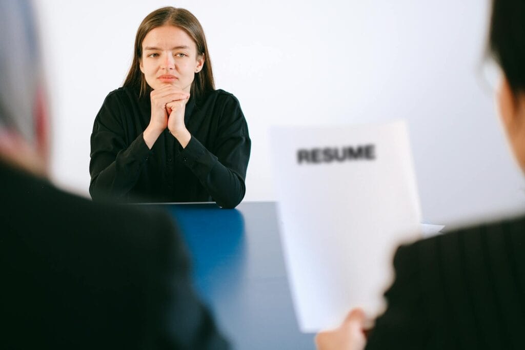 Woman with resume talking with human resource coordinator