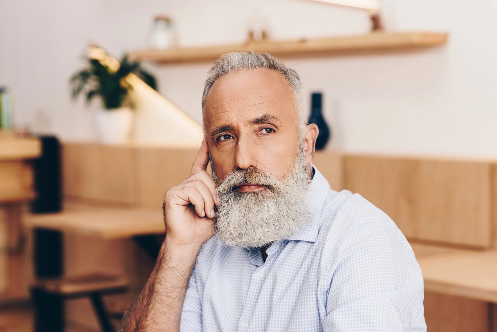 Senior man talking on smartphone in cafe
