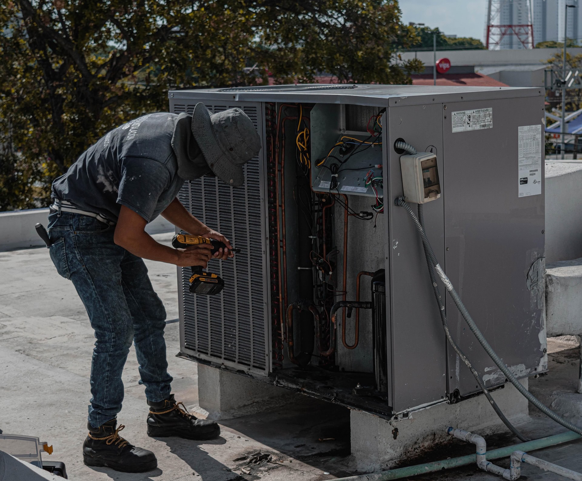 Man Drilling an Aircon Casing