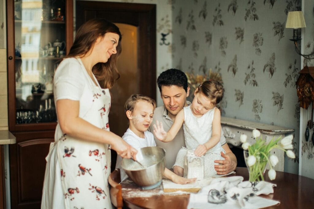 Photo of Woman Baking Near Her Family