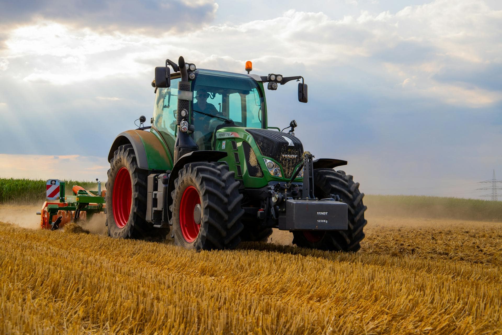Farmer using tractor plowing field
