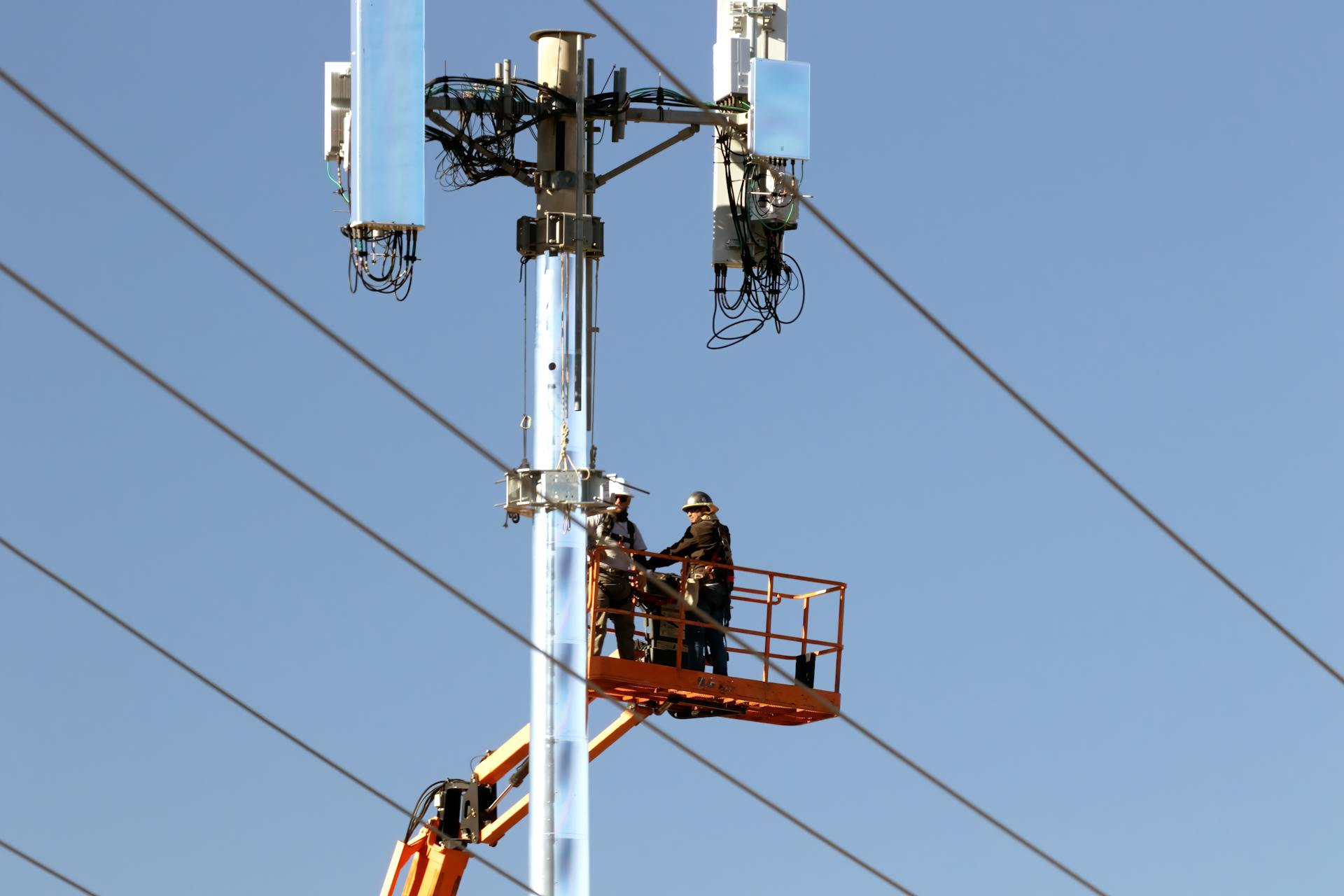 Two Workers Beside a Telephone Pole