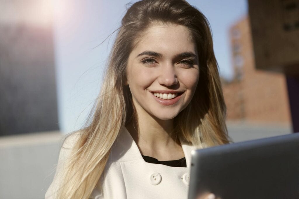 Smiling Woman in White Button Up Shirt