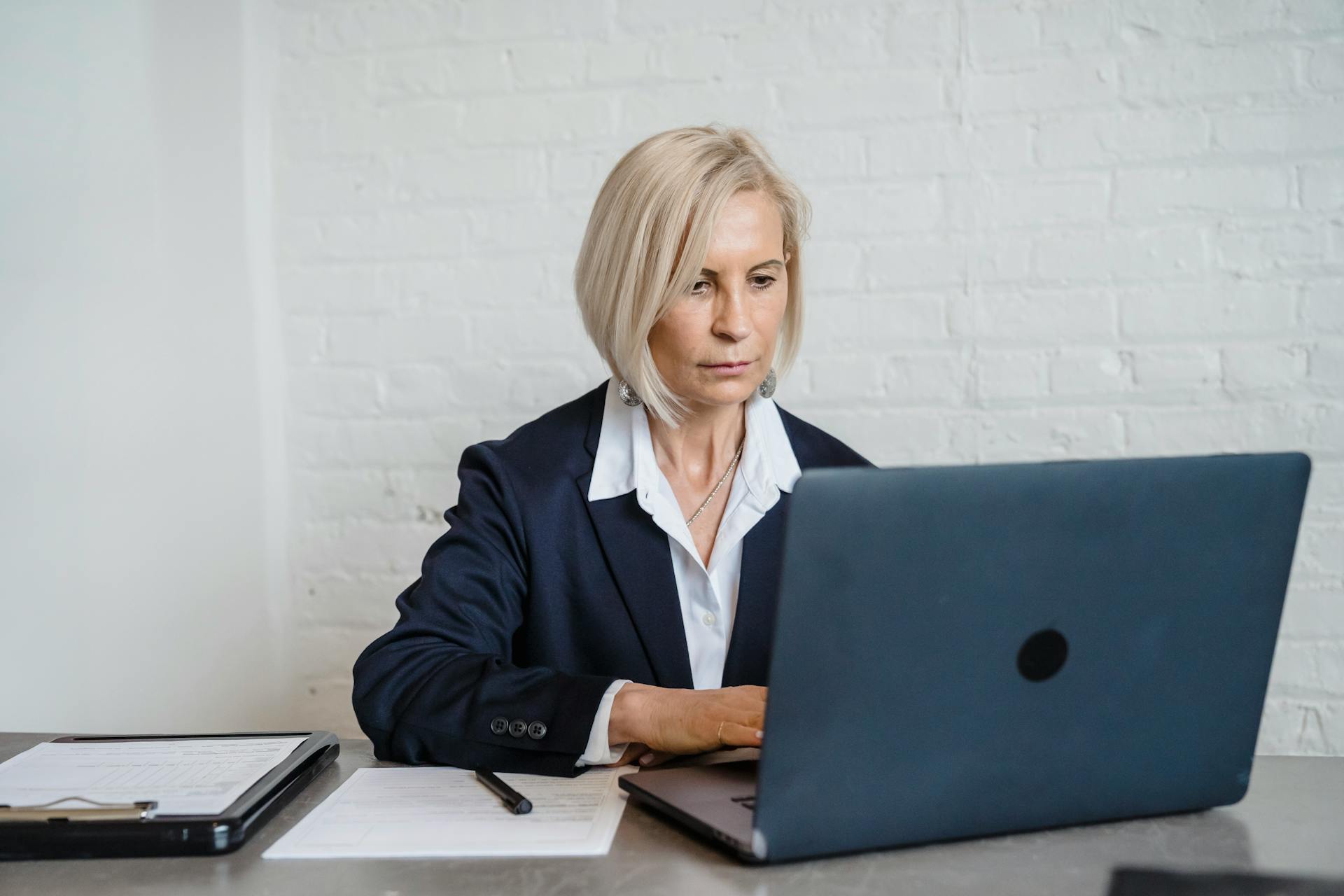 Woman Sitting in Front of a Laptop