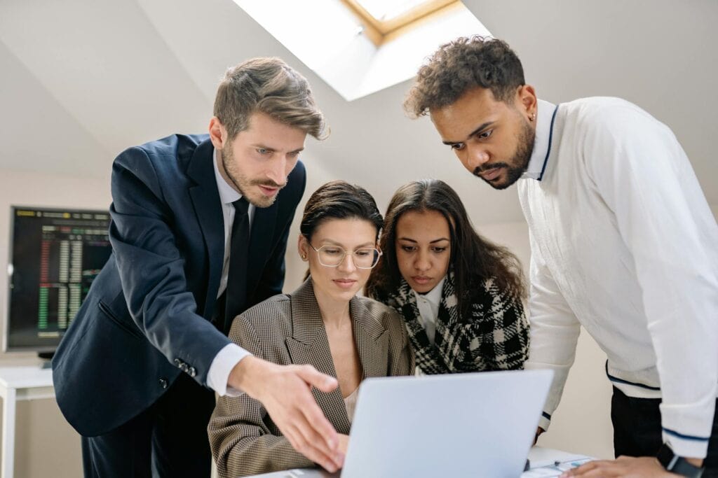 Women and Men Working over Laptop