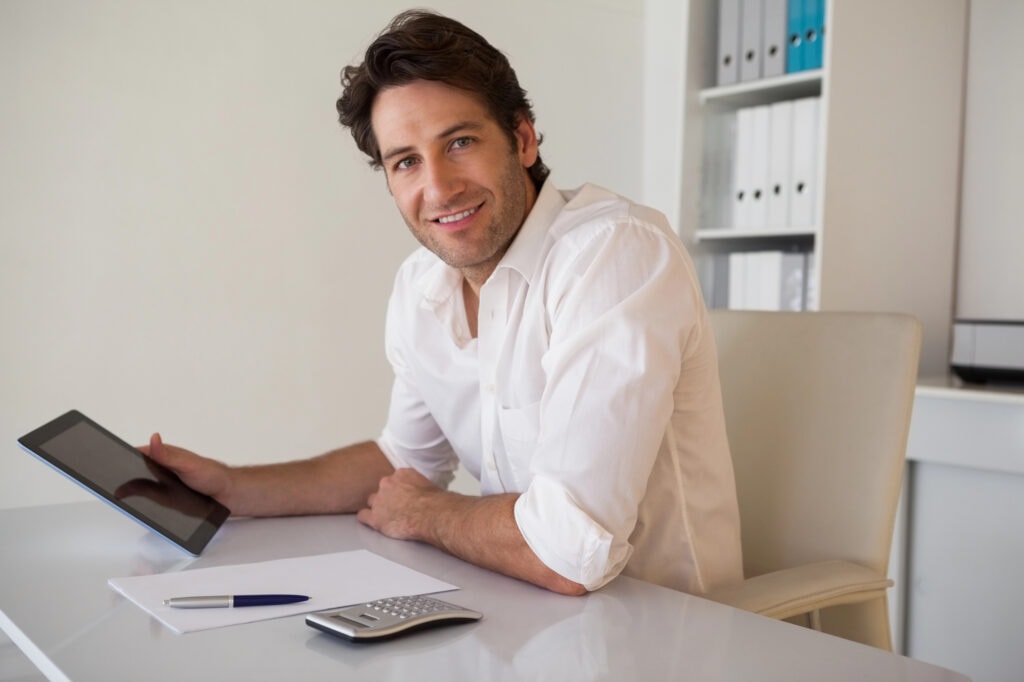 Businessman using tablet and calculator