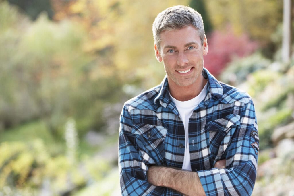 Man Standing Outside In Autumn Landscape